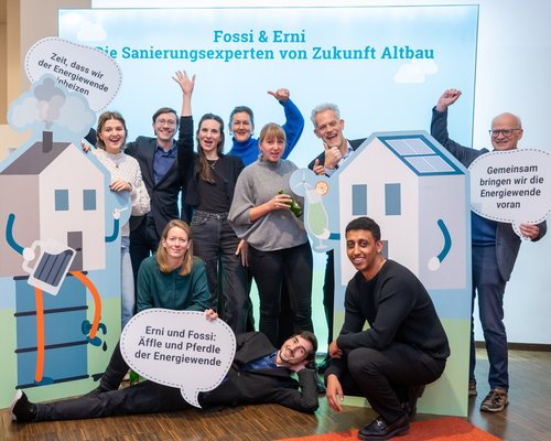 Das Foto zeigt mehrere Personen beim Posieren vor der Fotowand auf dem Herbstforum Altbau 2025.